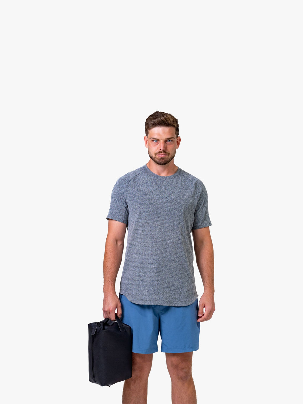 Athlete holding the Myo+ leather recovery bag, showing scale and carry handle